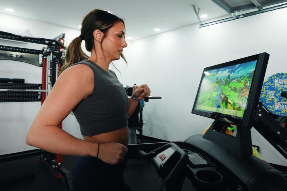 Lindsay Scheele, CPT does some gamified running on an Aviron Victory Treadmill
