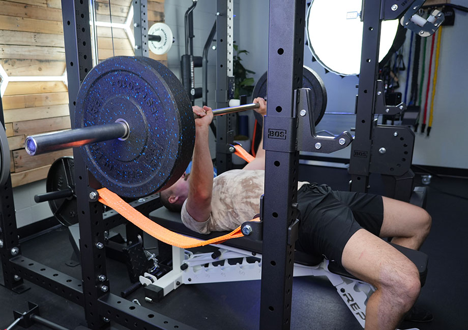 Coop performing a barbell bench press