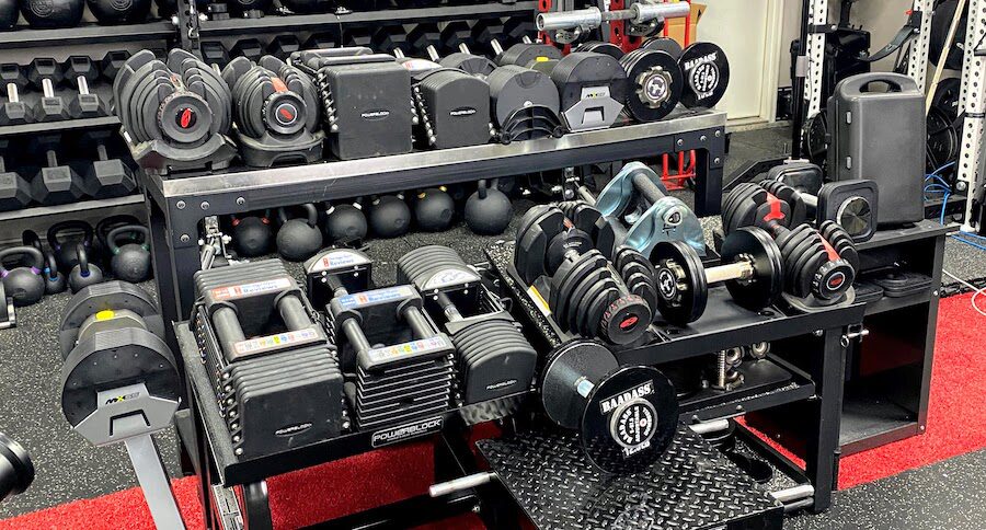 Dumbbell rack full of adjustable dumbbells