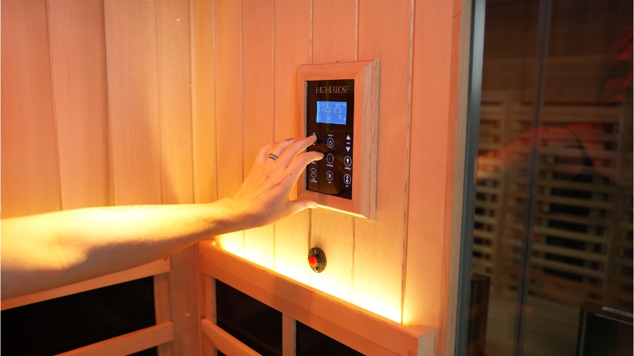Close up of a person using the control panel in the HigherDOSE Infrared Sauna