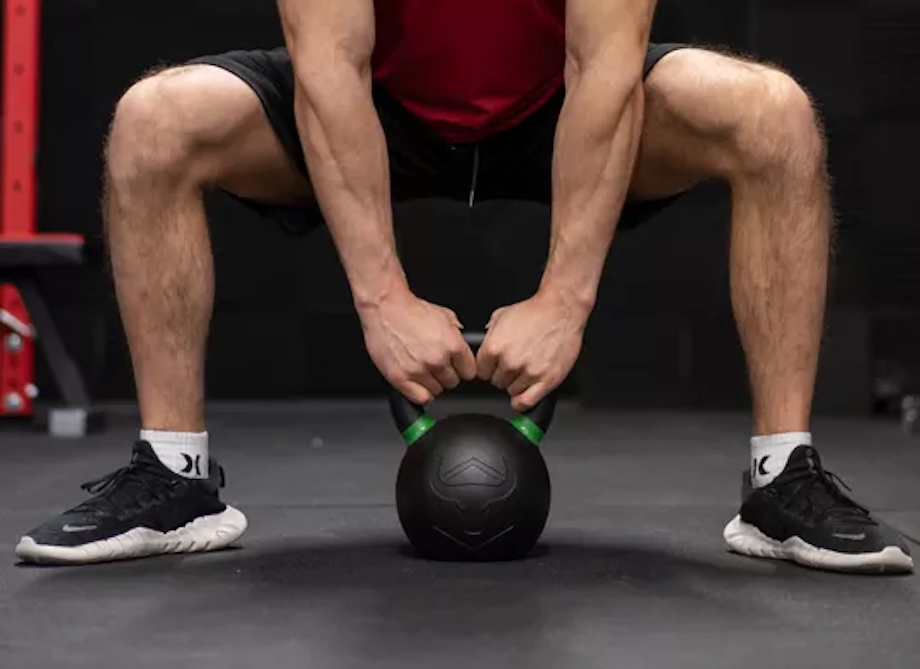 Man performs sumo deadlifts with the Iron Bull Kettlebell