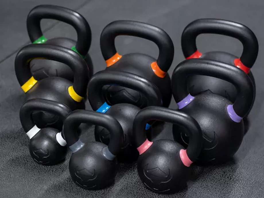 A set of Iron Bull kettlebells on gym flooring