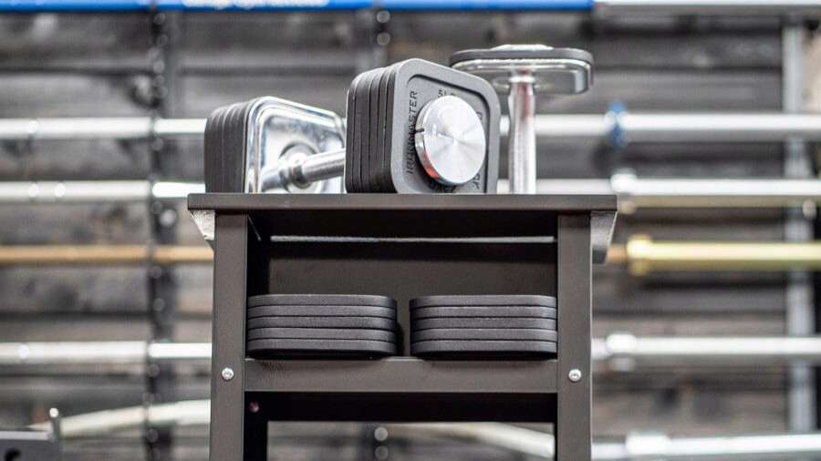 Ironmaster dumbbells on a dumbbell stand with weights