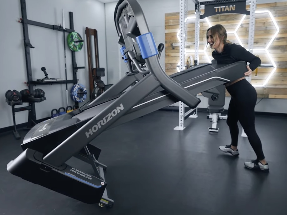 Product tester moving the Horizon 7.0 AT treadmill