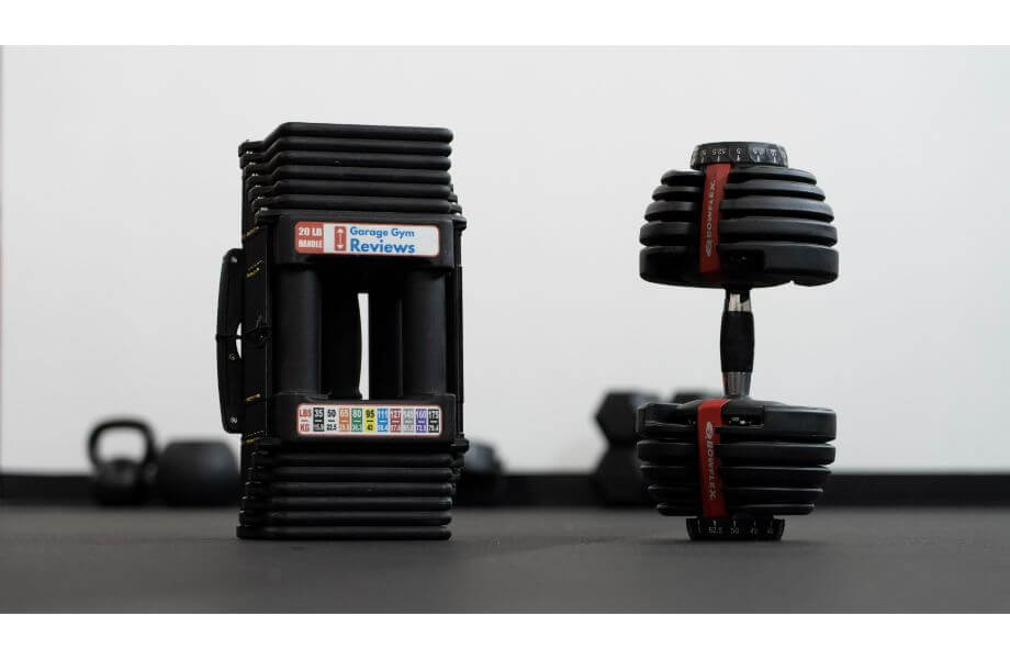 photo of powerblock and bowflex adjustable dumbells black product on white background