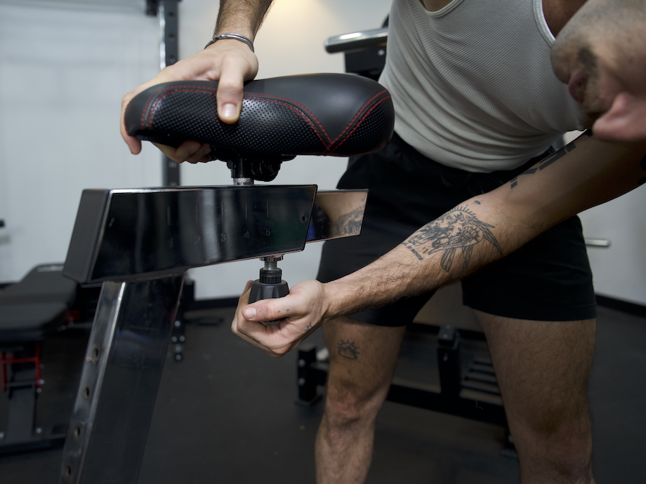 Man adjusts the seat on the Rogue Echo bike