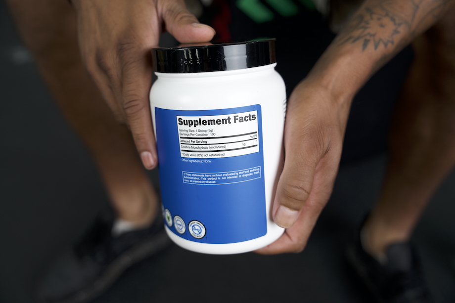 Product tester showing the supplement facts label on a container of Nutricost Creatine