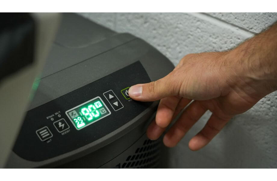 Someone adjusting the temp settings on a cold plunge