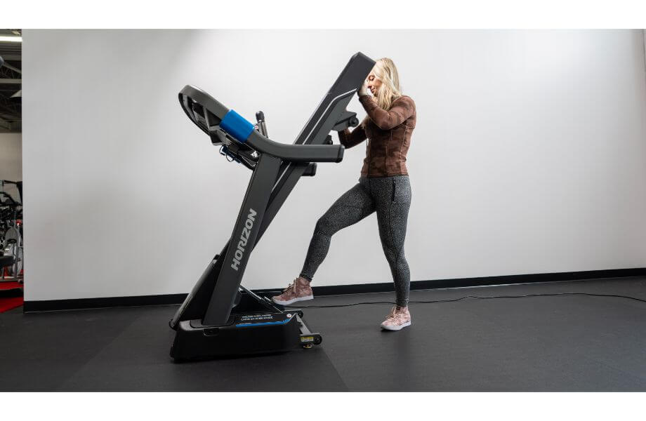 Woman folding up the Horizon 7.0 treadmill