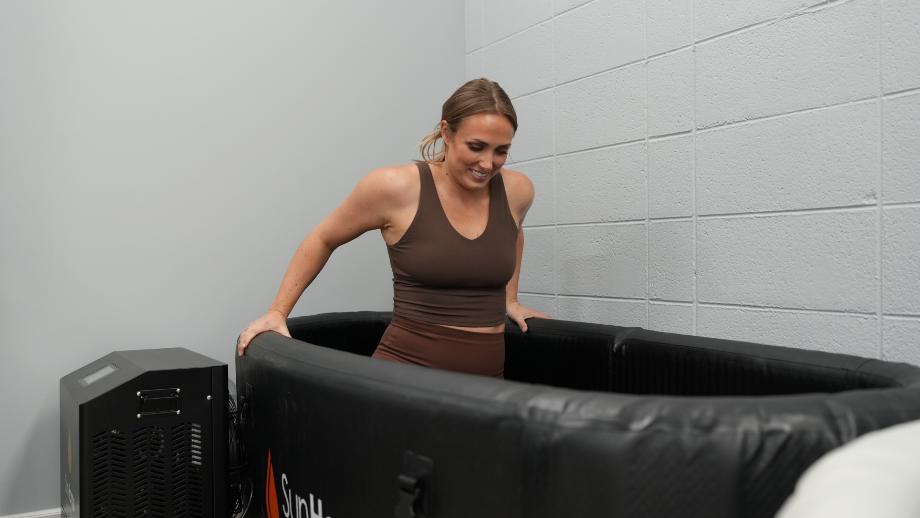 Woman lowering into Sun Home Cold Plunge