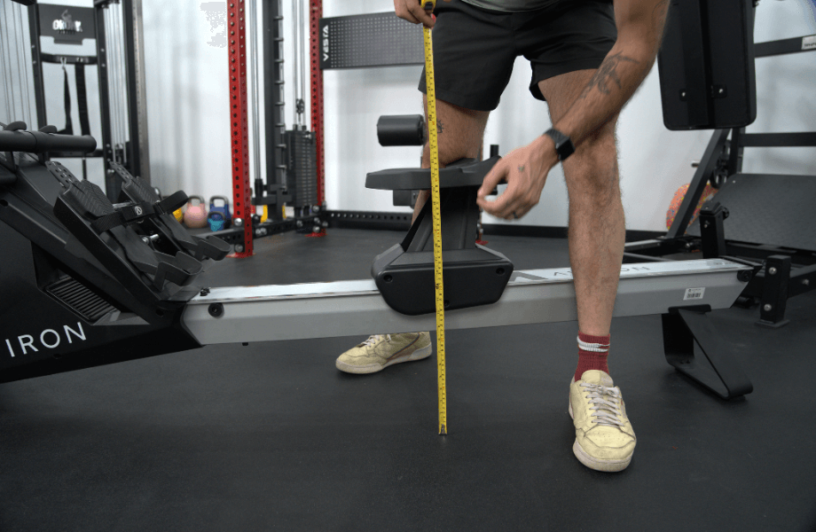 Our tester measuring the seat height of an Aviron rowing machine