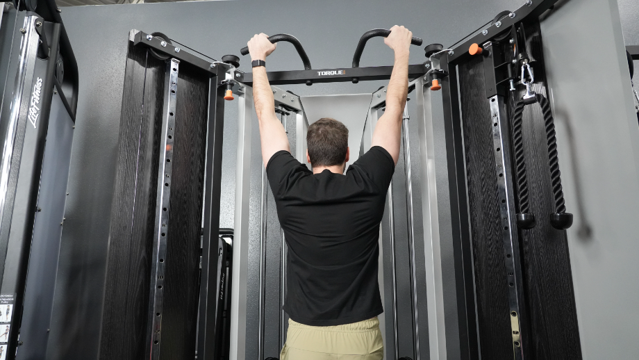 A man preforming pull-ups on the Torque F9